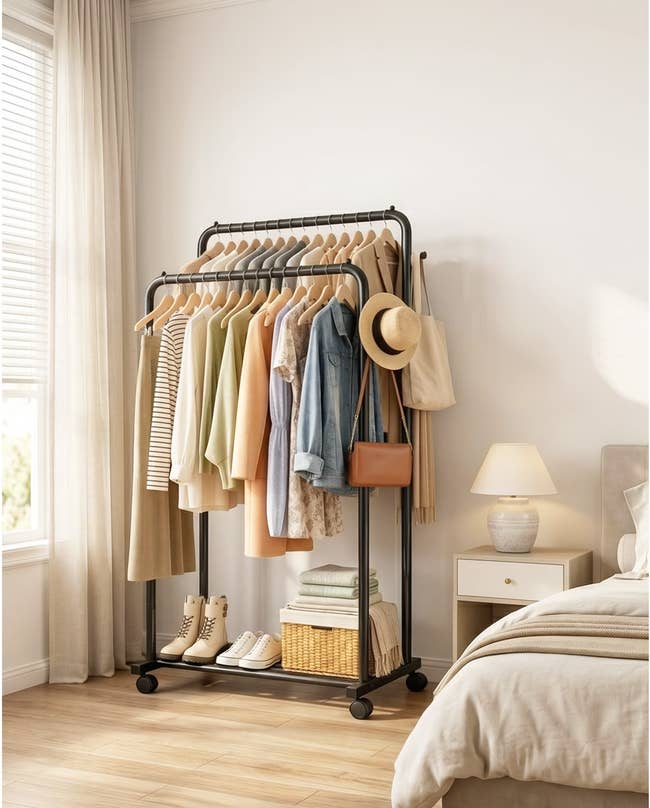 Clothing rack successful a chamber holding assorted outfits, a straw hat, and a purse, adjacent to a furniture and a nightstand with a lamp