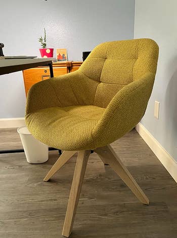 a reviewer photo of the chair in mustard yellow 