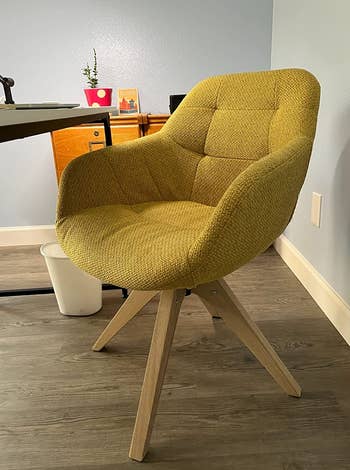 a reviewer photo of the chair in mustard yellow 