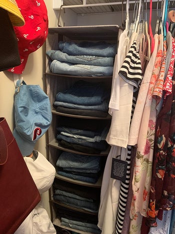reviewer hanging closet organized with folded jeans