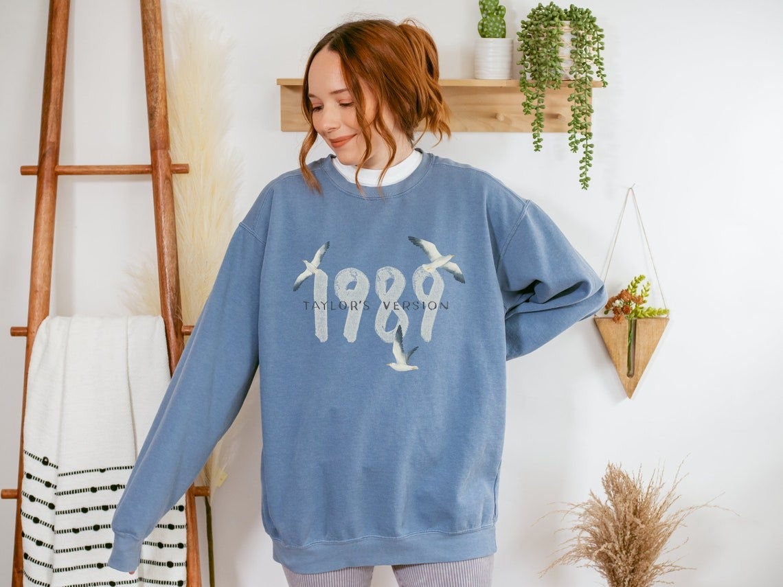 model wearing the blue 1989 sweatshirt