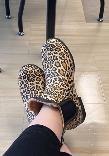 reviewer wearing leopard print slip-on boots