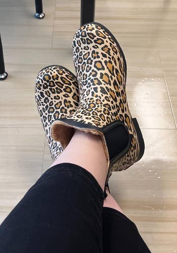 reviewer wearing leopard print slip-on boots