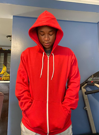 reviewer wearing the hoodie in red