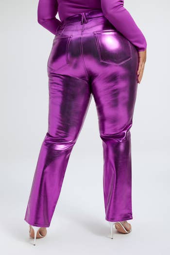 back of a model wearing purple metallic faux leather pants