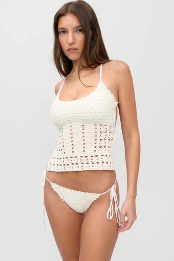 Person models white crochet tank top and bikini bottoms
