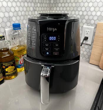Ninja air fryer on kitchen counter with digital display