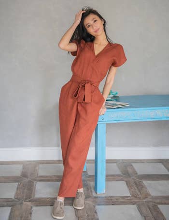 model wearing the rust colored jumpsuit