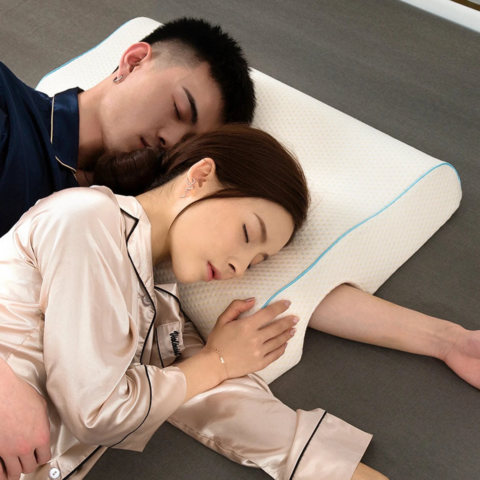 side pillow with hole for an arm. couple spooning with big spoon's arm through the hole.