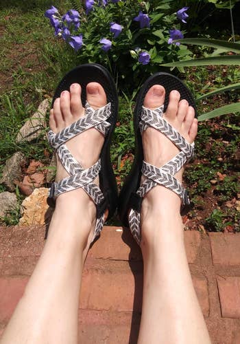 reviewer wearing the grey and white patterned chacos