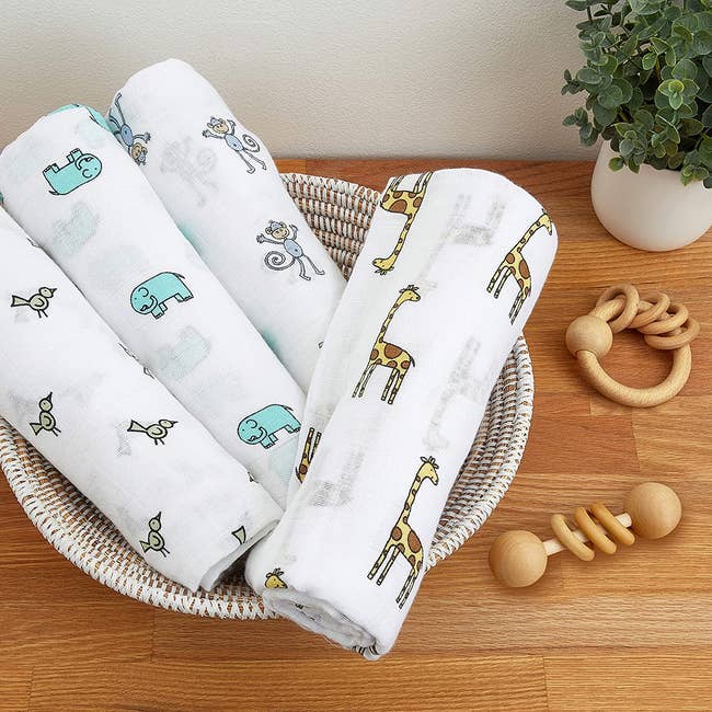 four muslin blankets with various animals on them