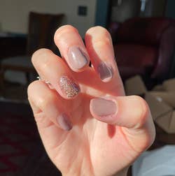 reviewer's gel manicure with sparkles on one finger