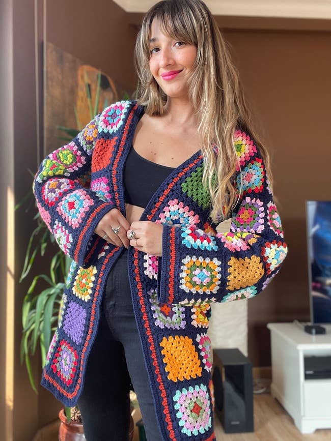 model posing in the the navy blue granny square cardigan
