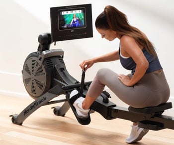 a model adjusting the pedals of a rowing machine