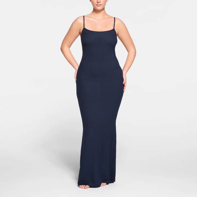 A model posing in the navy maxi dress