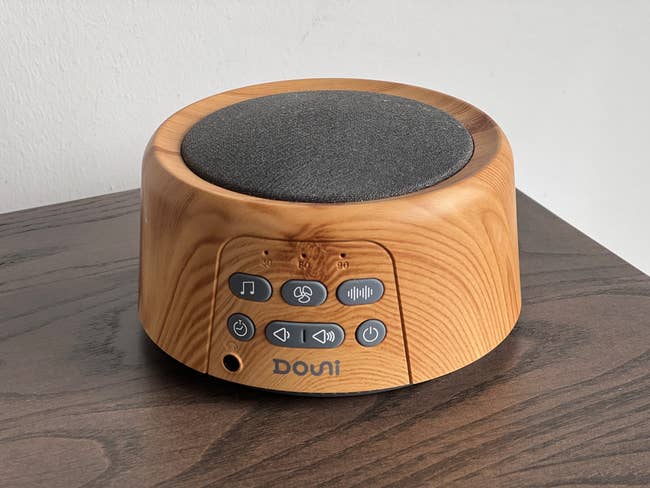Reviewer's photo of round, light wood-finished sound machine with gray speaker
