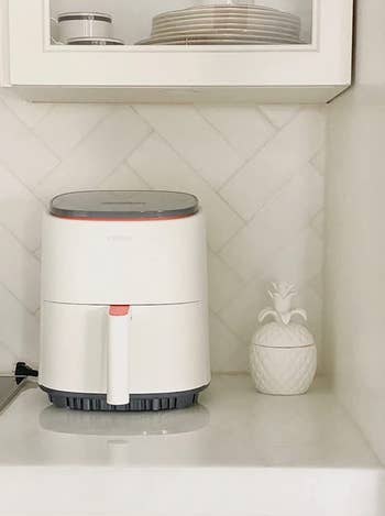 reviewer's white air fryer on a countertop