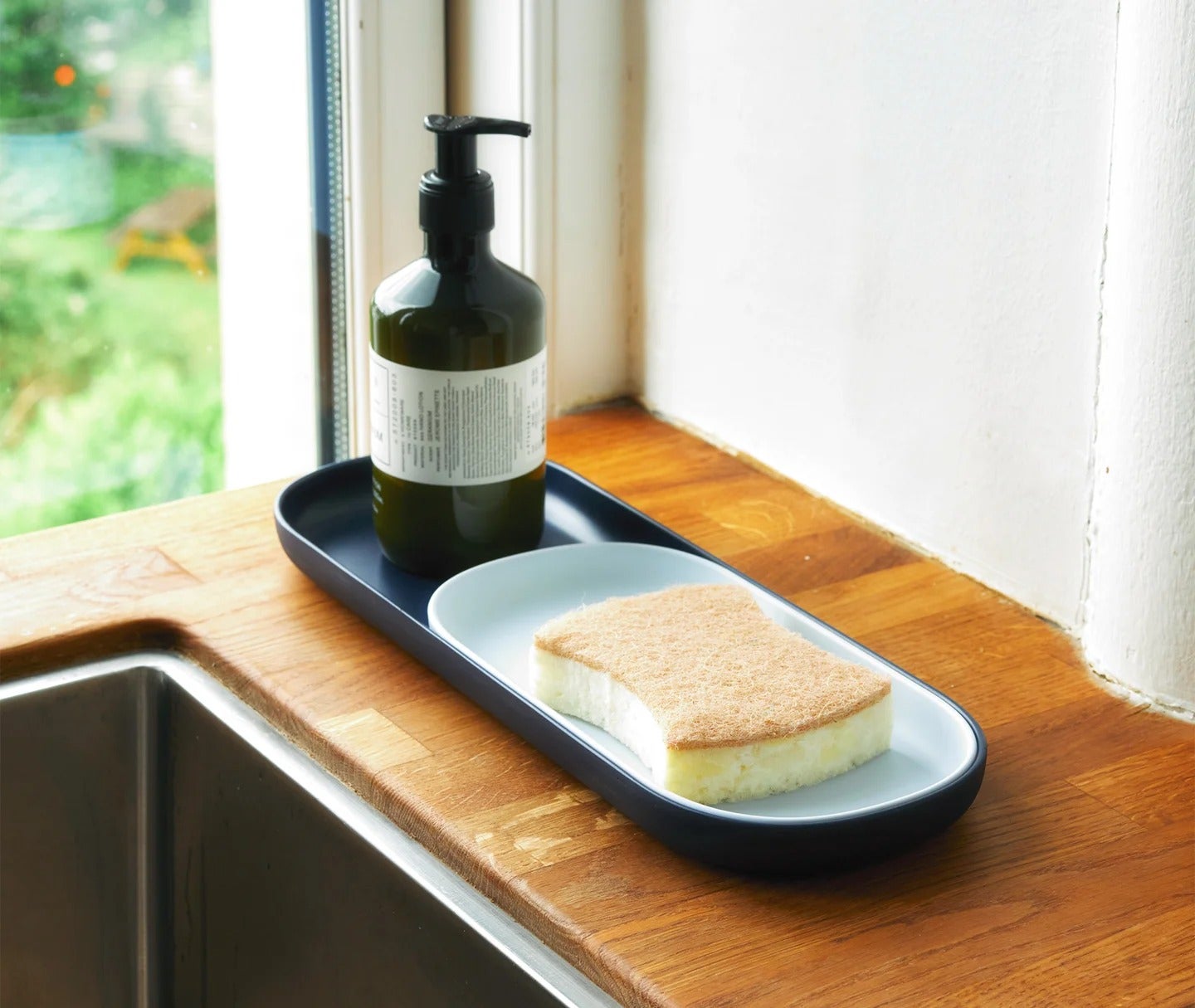 Rounded rectangle trays stacked within each other in in dark blue, light blue, and beige