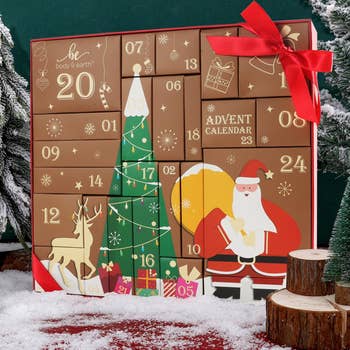 Advent calendar with a festive Santa and Christmas histrion design, featuring numbered boxes for countdown, surrounded by snowfall and vacation decor