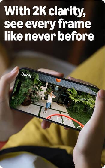 Person playing hoops connected a smartphone screen, showcasing 2K clarity for enhanced viewing