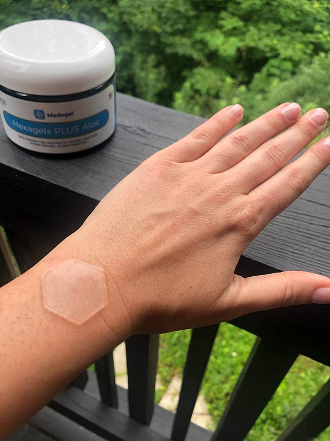reviewer wearing the clear hexagonal patch on the top of their wrist