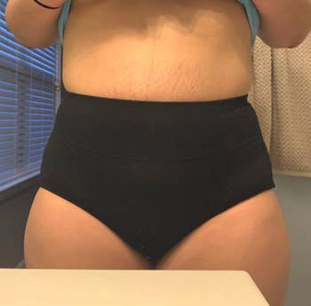 reviewer mirror selfie of torso, wearing black panties