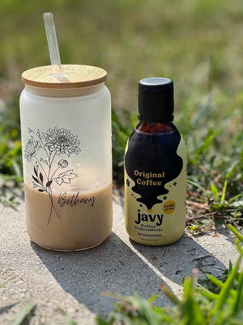 reviewers glass of iced coffee next to bottle of Javy