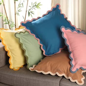 Decorative pillows with scalloped edges connected  a sofa, featuring assorted  coagulated  colors, suitable for location  decor buying  inspiration