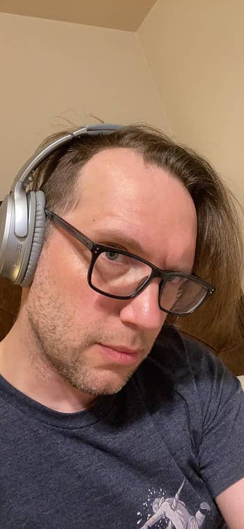 reviewer wearing their silver Bose headphones