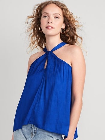 model wearing blue halter neck top 