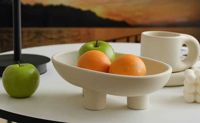 small ceramic fruit bowl with three legs