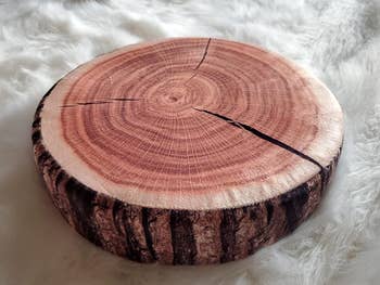 reviewer's photo showing a close up of the faux wood stump pillow