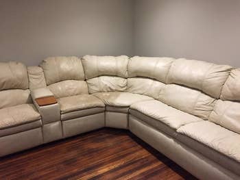 reviewer photo showing their white sectional half dirty, half cleaning restored after using the leather honey 