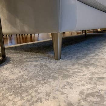 close up of brass metal legs supporting a sofa