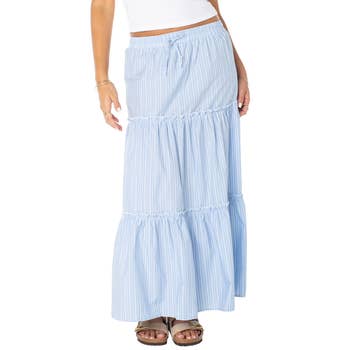 Woman wearing a tiered maxi skirt and sandals, ideal for summer shopping. Note: White top is partially visible