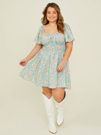 Model in floral dress and white boots