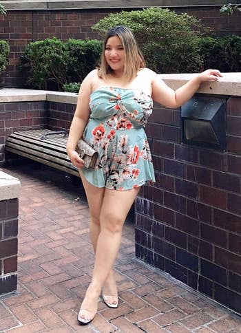 reviewer in a light blue romper with orange flowers