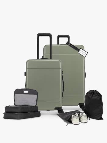 Two sleek suitcases with extended handles, packing cubes, a laundry bag, and a brace  of casual sneakers displayed for question   essentials shopping