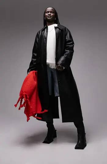 model in long leather look jacket