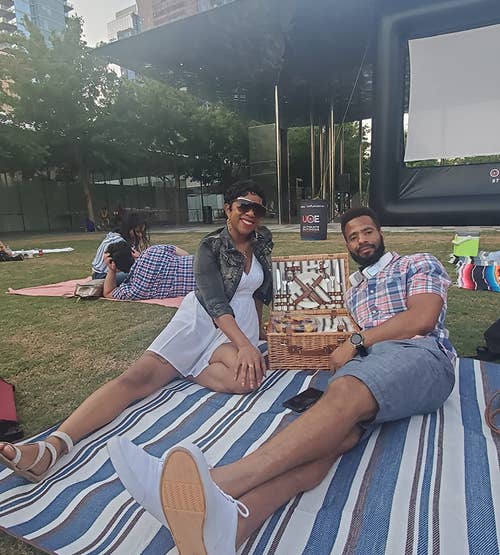 reviewers on the blue striped blanket at an outdoor movie screening