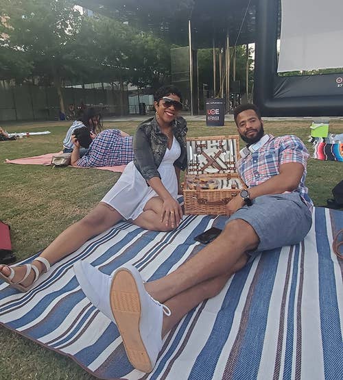 reviewers on the blue striped blanket at an outdoor movie screening