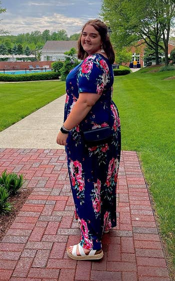 side view of a reviewer wearing a blue floral dress