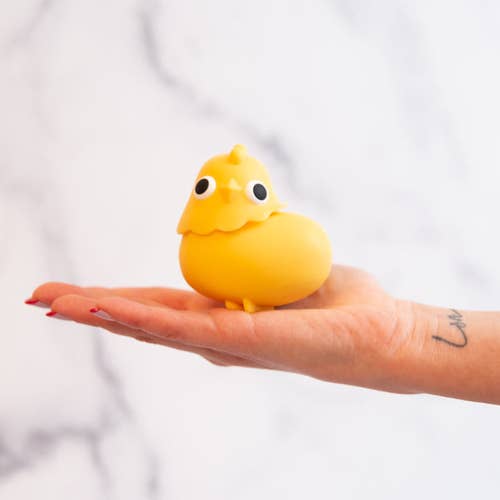 hand holding the yellow chick sex toy