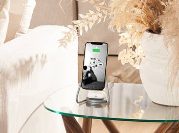 a standing magnetic phone charger that charges a phone and airpods at the same time