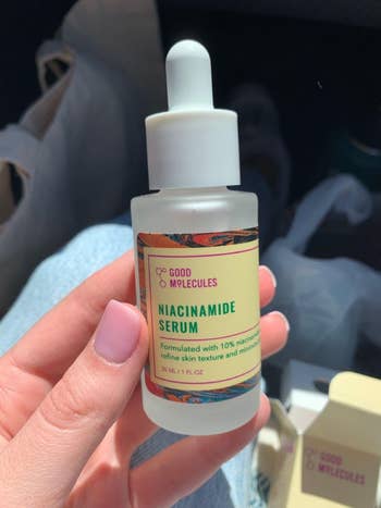 Hand holding a vessel  of Good Molecules Niacinamide Serum