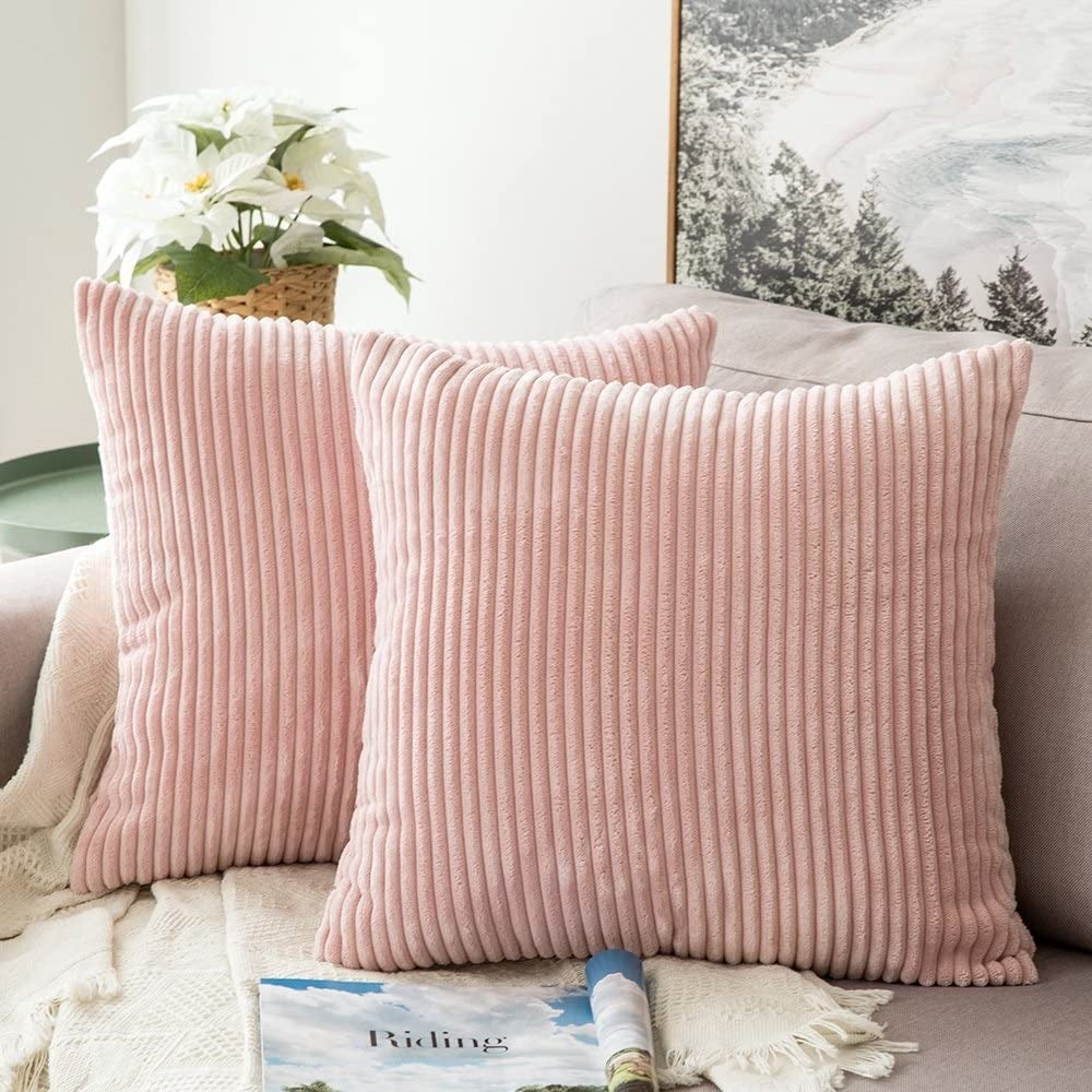 two pink corduroy pillows on a couch