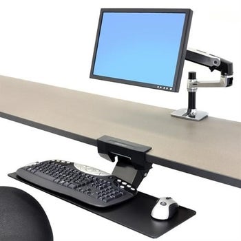 a black keyboard attachment under a desk holding a keyboard and mouse