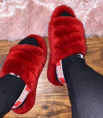 reviewer wearing the slippers in red