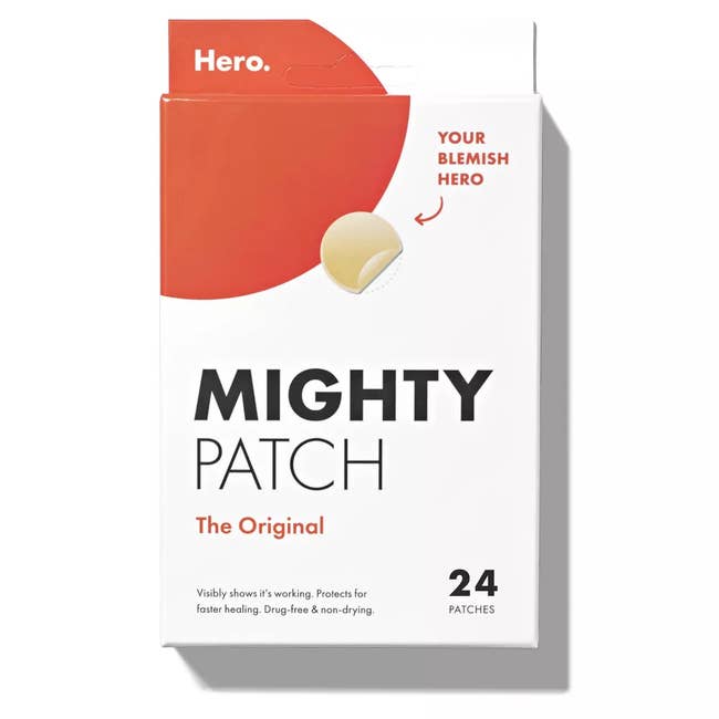 Pimple patches in a small white box with dark orange accents by the brand Hero Cosmetics 
