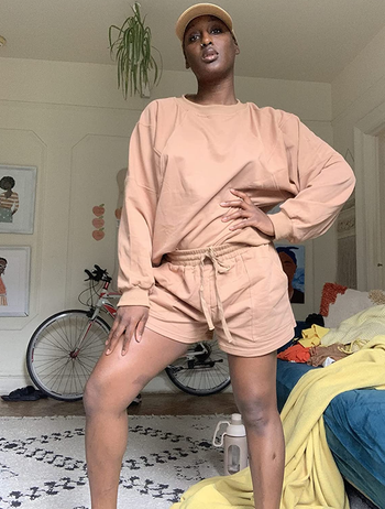 reviewer wearing the tan shorts set